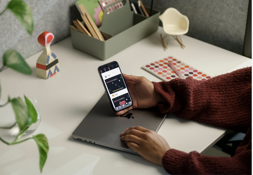 Hand holding an iPhone. An app is displayed.