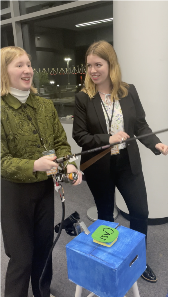 two women playing a fishing game